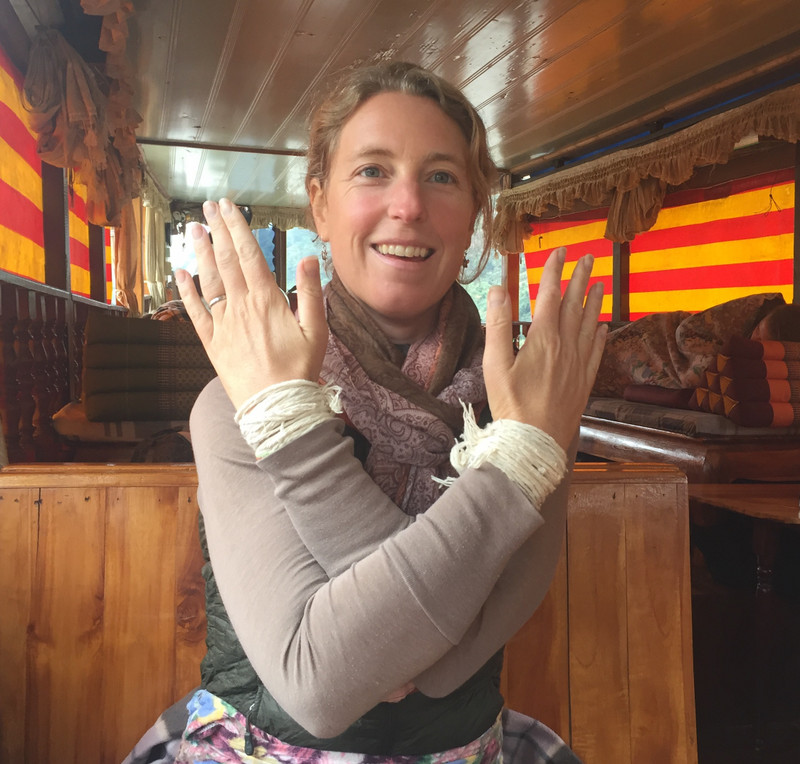 Absorbing my bracelet-wishes on the Mekong boat.
