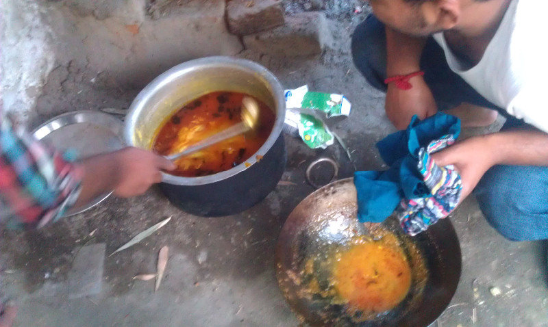 Mixing the boiled dahl with the fried spicy mixture 