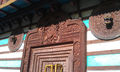 Wood carving on larger temple entrance