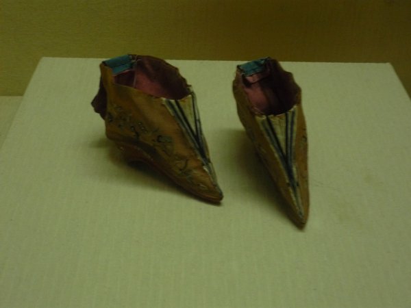 A tiny pair of silk embroidered shoes from foot binding days