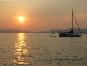 sunset sailing boat