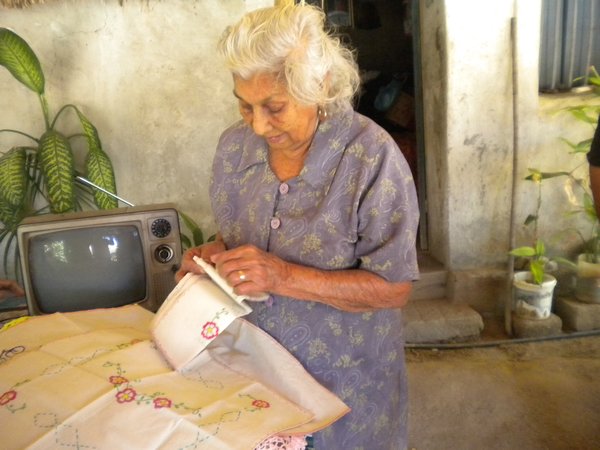 Lady shows her embroidery