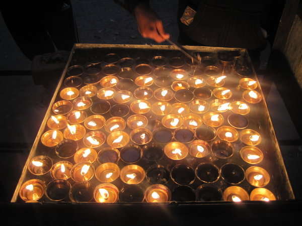 Lighting candles at the temple