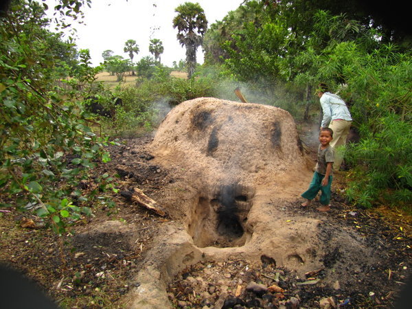 an old termite mound being used for a charcoal oven