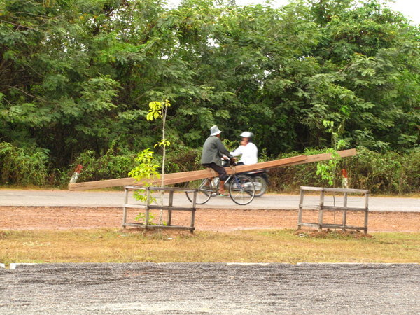 how a Cambodian  brings home a 30' long 2x6