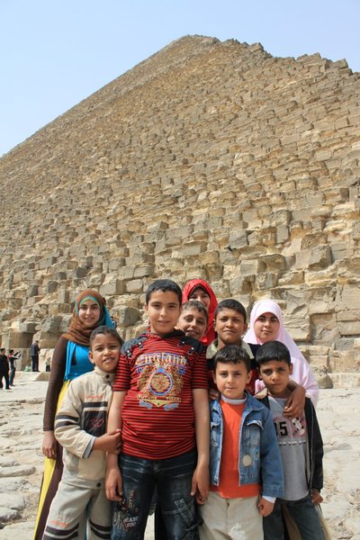 Happy kids in front of the Great Pyramid of Khufu (Cheops) 