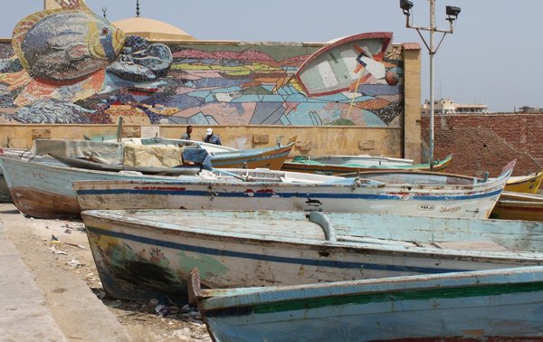 Colourful fishing boats line the shore in Alexandria