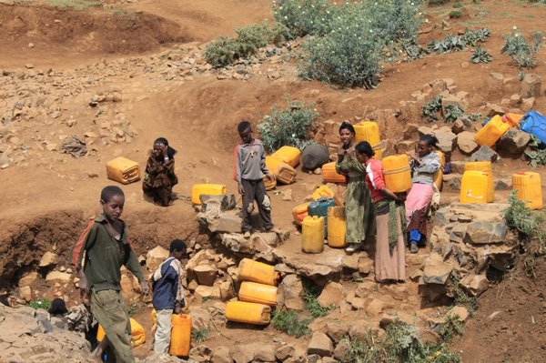 People collecting their daily water supply