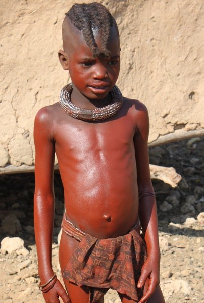 A young girl, the thick necklace means she is not yet married