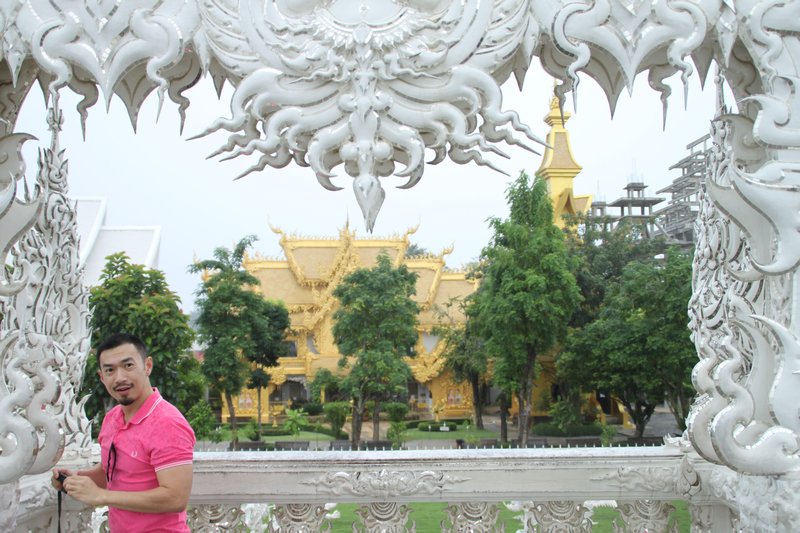 Pod framed by Wat Rong Koom