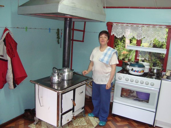 Reception,Kitchen and dinning room with the lady owner. standing by her wood burning cooker and heater.