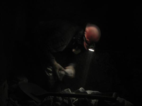 miner working by headlamp light