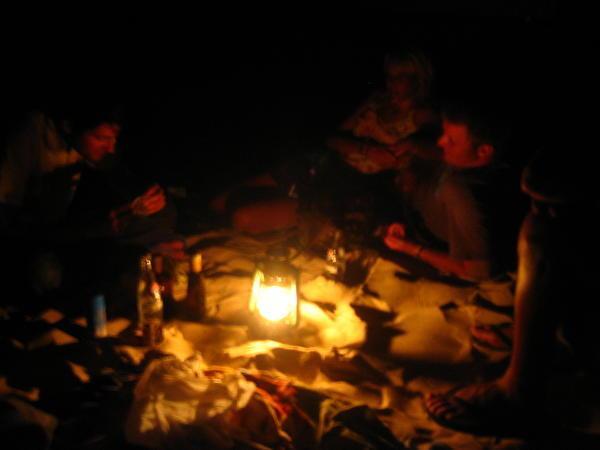 party continues on the beach by lamp light