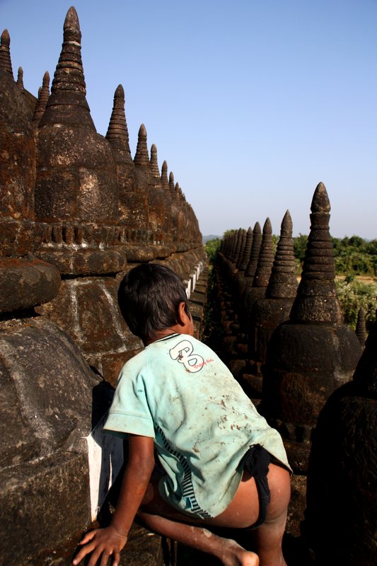 Boy Playing Around Stupas