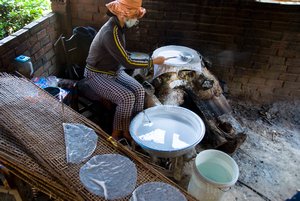 Woman making rice paper wraps