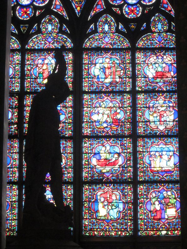 Cool stained glass and statue inside Notre-Dame