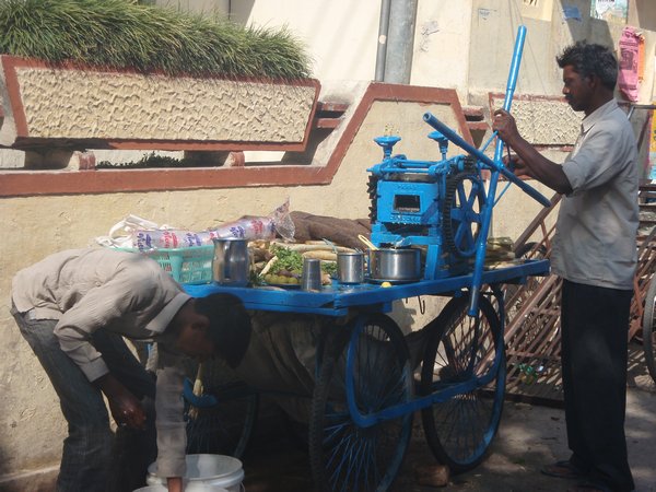 Making sugar cane juice by hand