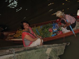 Lilan down at the night floating market chatting with the vendor