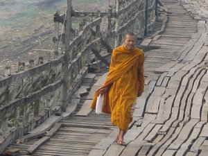 Monk walking on the Wang Kha Bridge
