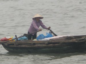 Female water taxi driver in Halong Bay