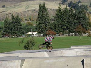 boy and their bike over the ramp