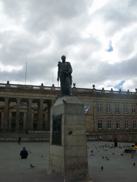 Statue of Bolivar in Plaza Bolivar, with the Senate in the background.