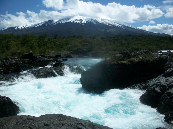 Petrohué Waterfalls with a cloudy Osorno Volcano in the background