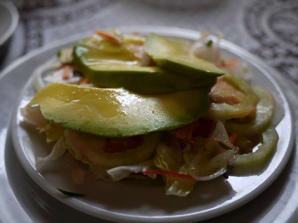 A salad with oversized avocado