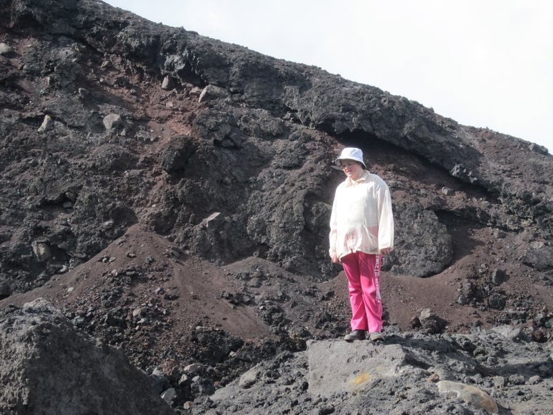 Dana standing on the volcanic rocks