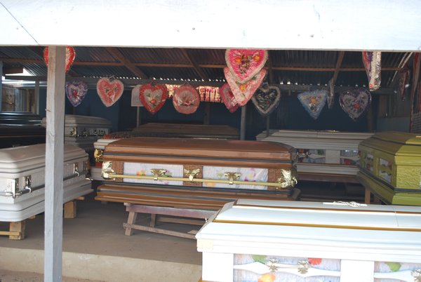 hand made coffins are sold by the roadside everywhere
