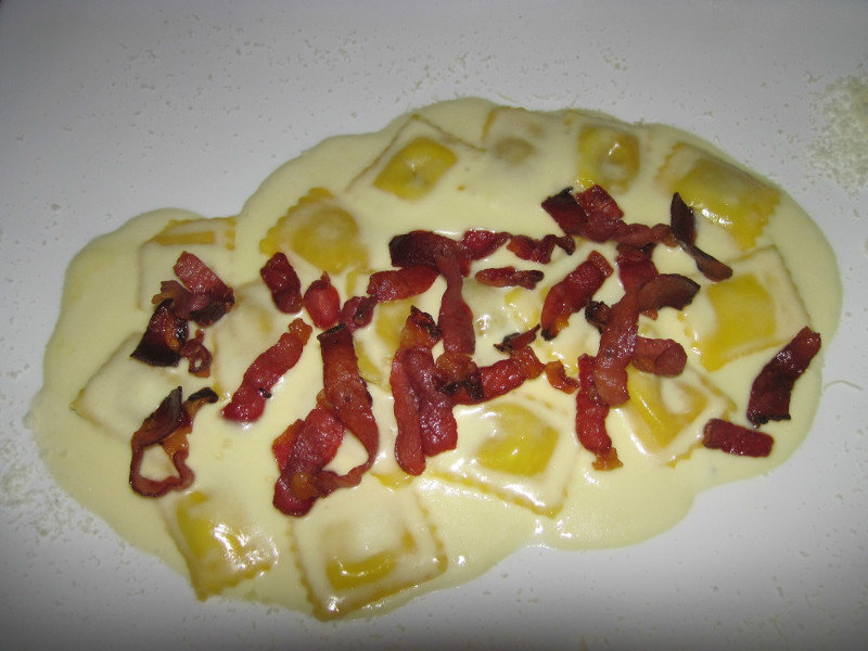 porcini ravioli in cheese sause with speck