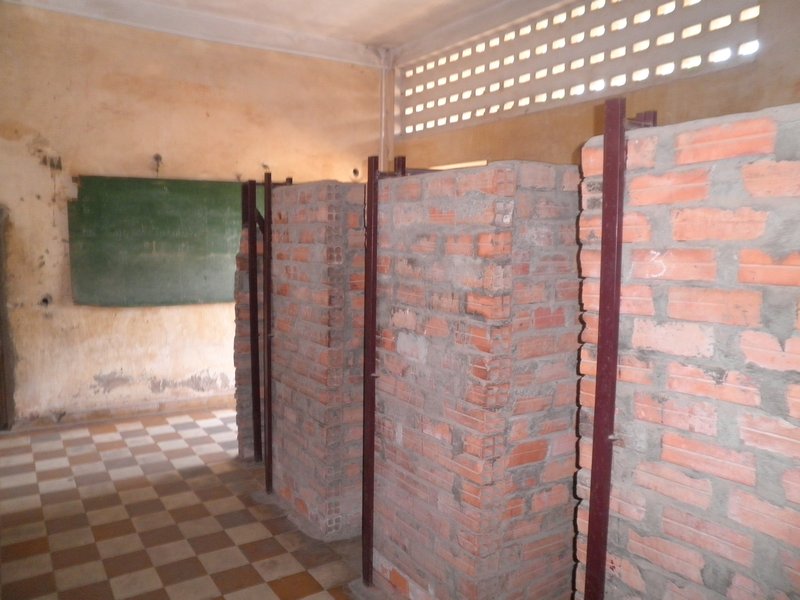 Makeshift cells constructed for the prisoners (a blackboard in the background)