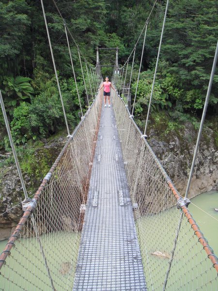 suspension bridge along charming creek walkway