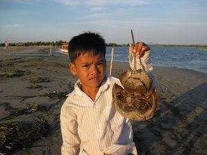 Khmer boy with his beach findings