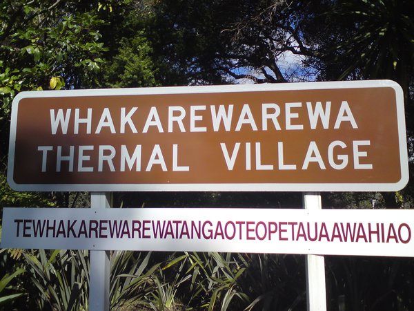Sign for the village. The Maori name is in the single word in white!