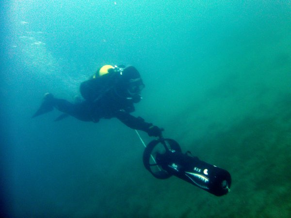 Scuba diving with an underwater scooter