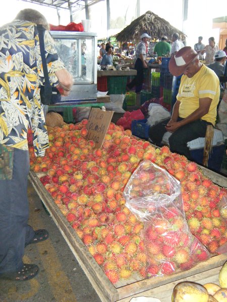 Noe buying lychee type fruit.