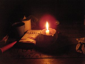 Reading by candle light.