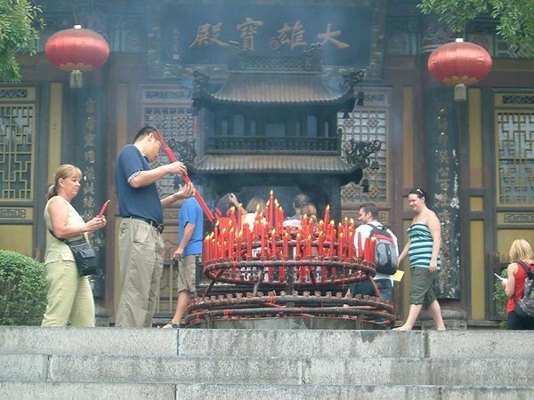 Lighting candles at buddist temple