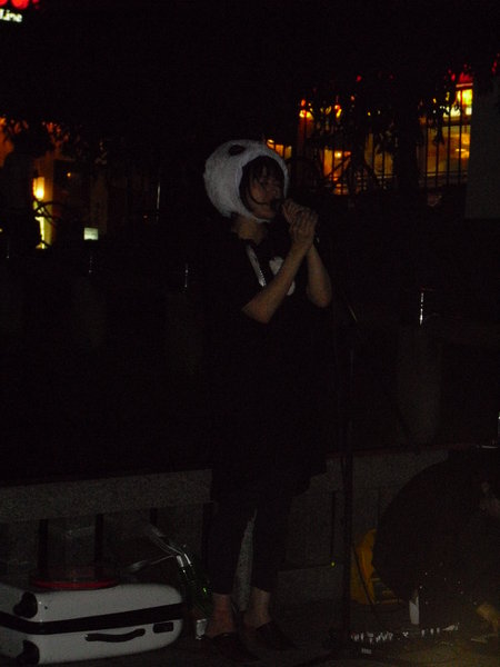 Strange woman dressed as a panda singing in the street