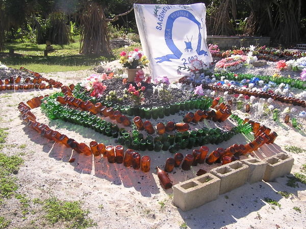 Local burial styel... yes those are beer bottles.