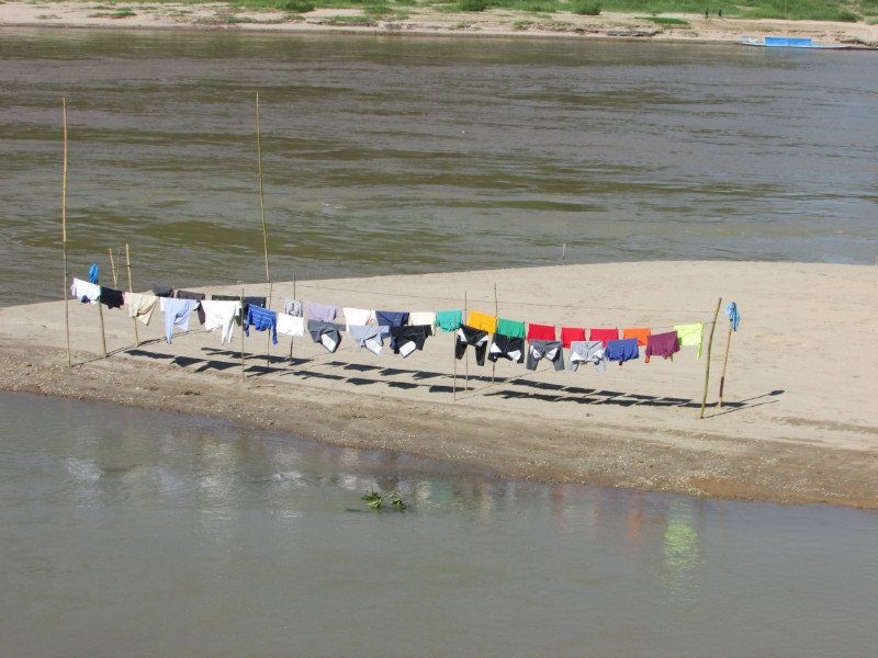 Drying Colorful clothes along the Mekong River