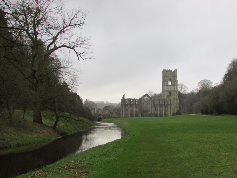 Fountains abbey with the stream that runs along the abbey complex