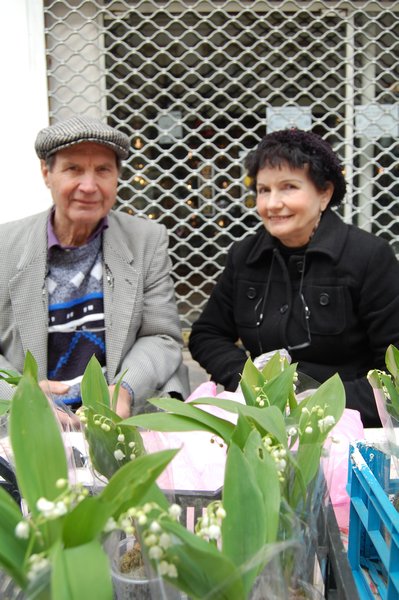 Couple selling flowers for May 1st.
