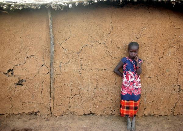 Masaii girl outside her hut.