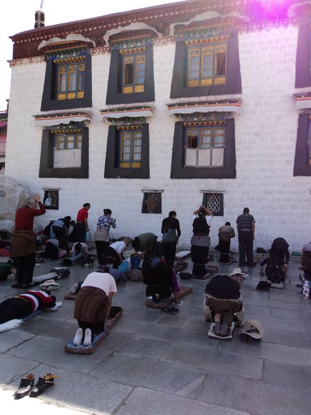 Buddhists prostrating in this side of the Jokhang Temple