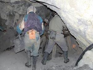 Miners working the pulley removing rubble from a lower shaft.