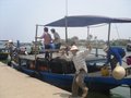 Locals carting their bikes across river by ferry - Hoi an