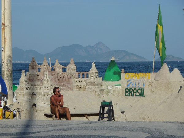 Carnival sand structure plus typical half naked Brazilian man in Eurotrunks