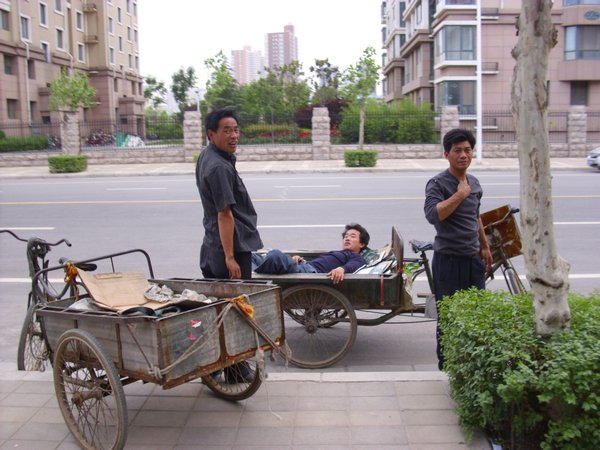 Guy having a kip in his rickshaw